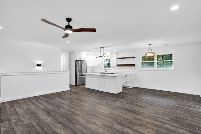 kitchen featuring pendant lighting, plenty of natural light, white cabinets, and stainless steel fridge with ice dispenser