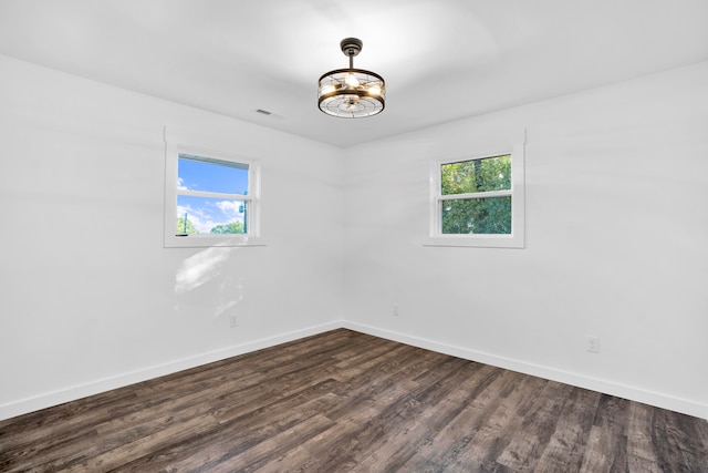 empty room featuring dark wood-type flooring