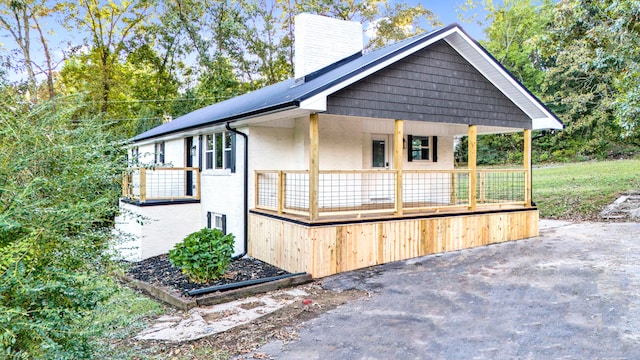 view of side of property featuring a porch