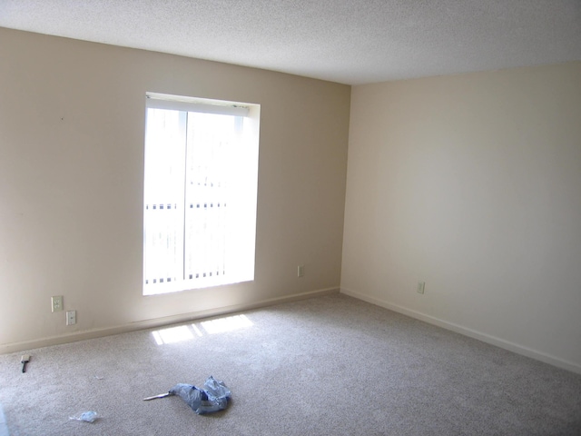 900 Stratford Cir NW, Cleveland, TN 37312 - spare room with a textured ceiling, carpet flooring, and baseboards