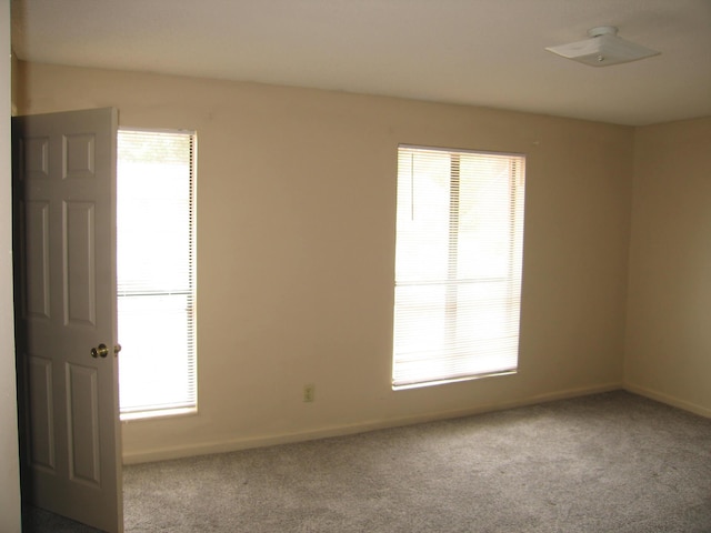 900 Stratford Cir NW, Cleveland, TN 37312 - carpeted empty room featuring a wealth of natural light and baseboards