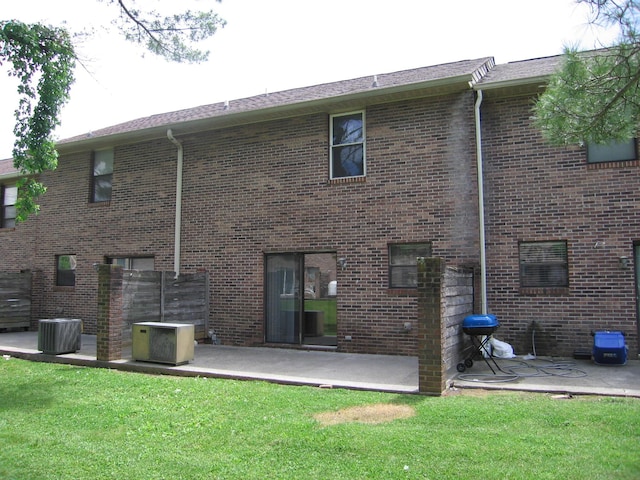 900 Stratford Cir NW, Cleveland, TN 37312 - back of house featuring a lawn, a patio area, central AC, and brick siding