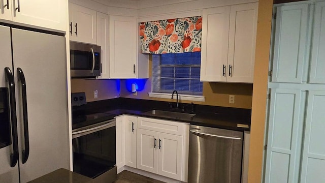 kitchen with sink, white cabinets, and appliances with stainless steel finishes