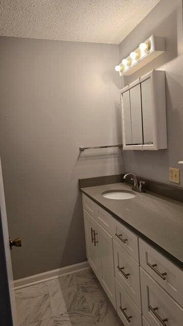 bathroom featuring vanity and a textured ceiling