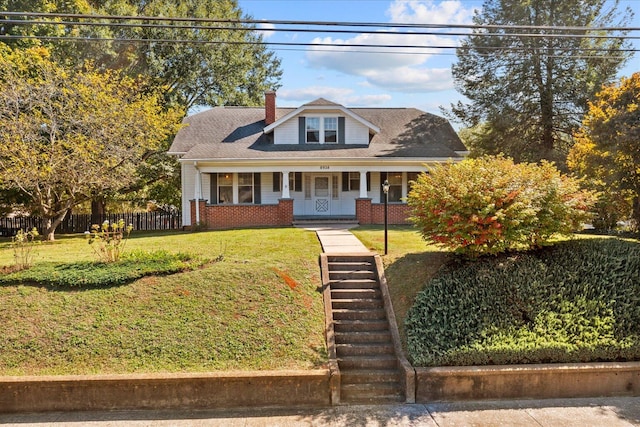 bungalow-style house with a porch and a front lawn