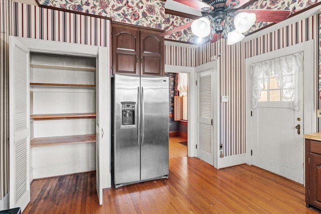 kitchen with dark brown cabinetry, stainless steel fridge with ice dispenser, ceiling fan, and hardwood / wood-style flooring