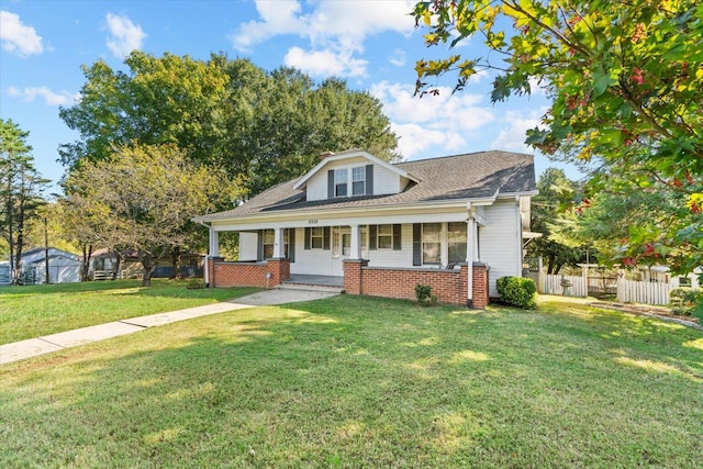 view of front of property with a porch and a front lawn