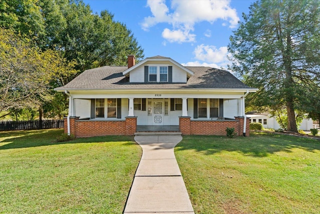 bungalow-style house featuring a front yard and covered porch