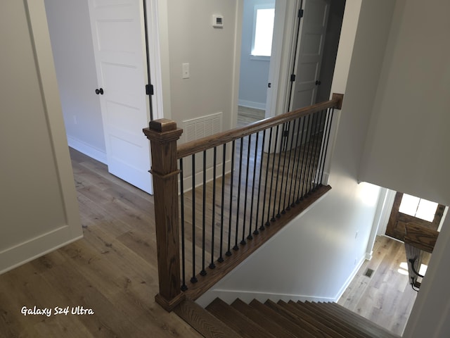 stairs featuring wood-type flooring