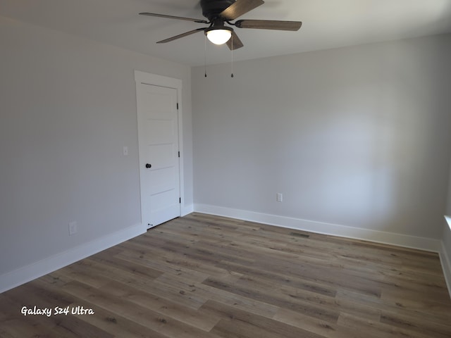 empty room featuring ceiling fan and wood-type flooring