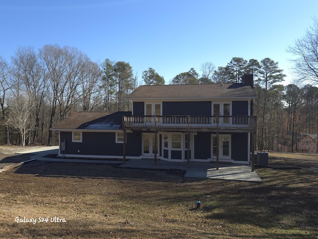 back of house with a yard, a patio area, french doors, and central air condition unit