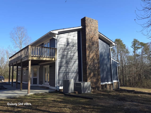 view of side of property featuring a patio and cooling unit