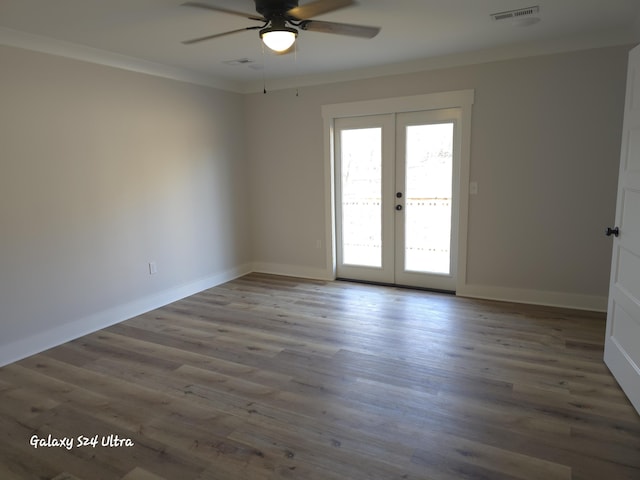 spare room featuring hardwood / wood-style flooring, ornamental molding, french doors, and ceiling fan