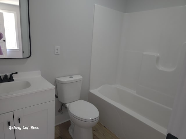 bathroom with vanity, hardwood / wood-style floors, and toilet