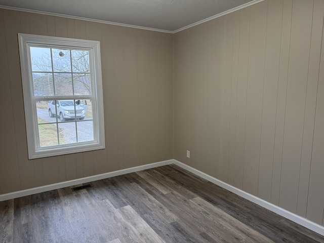 unfurnished room featuring crown molding and hardwood / wood-style flooring