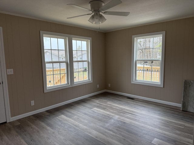 unfurnished room featuring wood-type flooring, ornamental molding, and ceiling fan