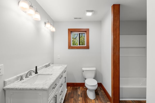 804 Eastanallee Ave, Athens, TN 37303 - full bathroom with baseboards, toilet, visible vents, a sink, and wood finished floors