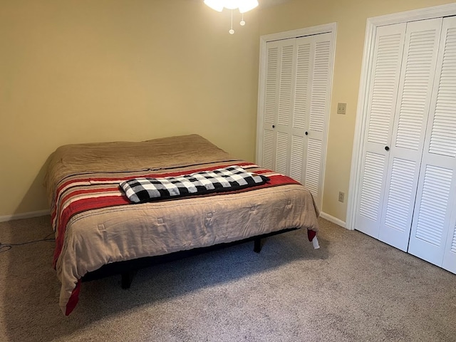 carpeted bedroom featuring two closets