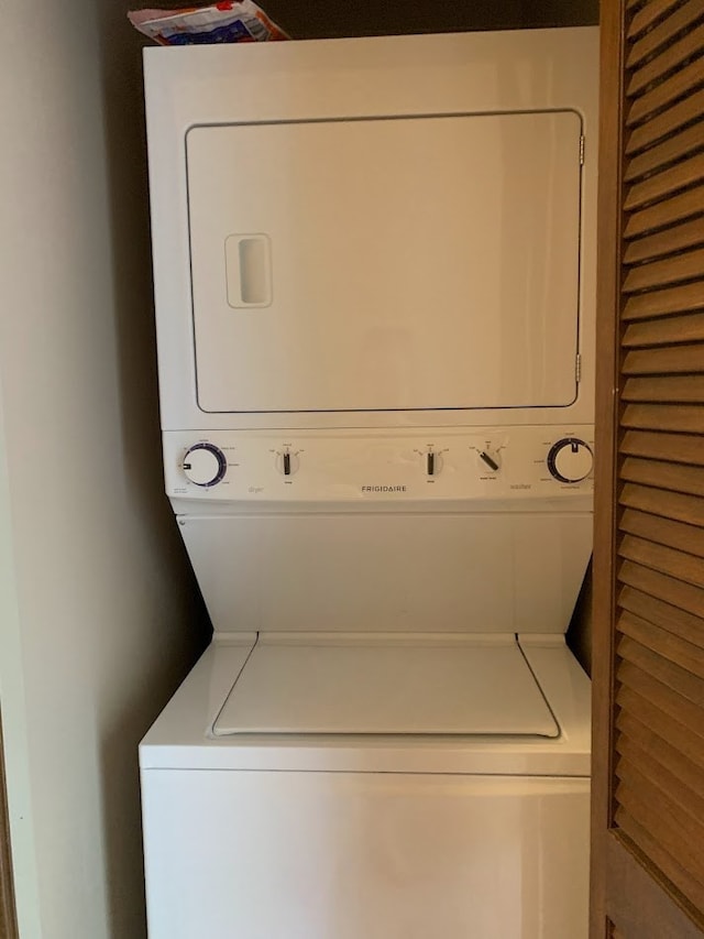 laundry room featuring stacked washer and dryer