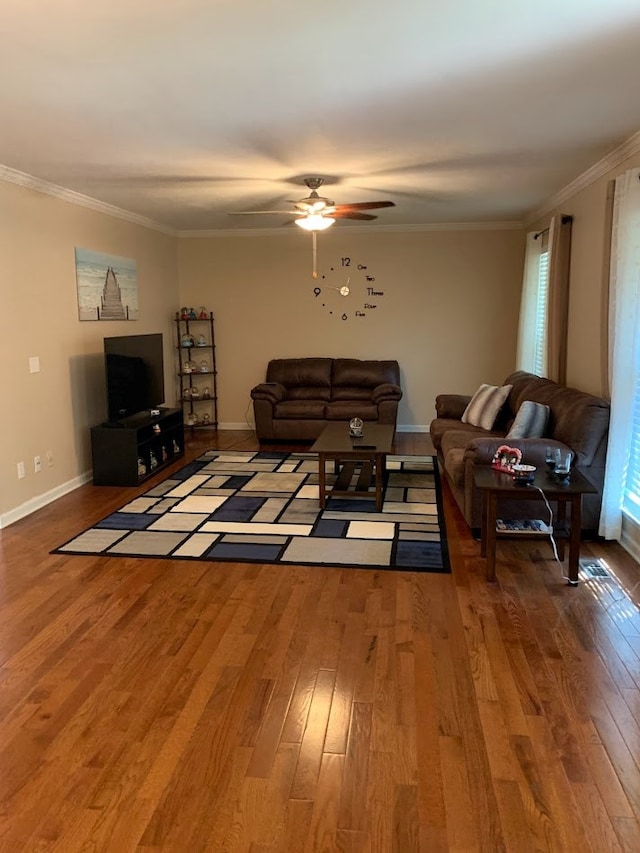 living room featuring hardwood / wood-style flooring, ceiling fan, and crown molding