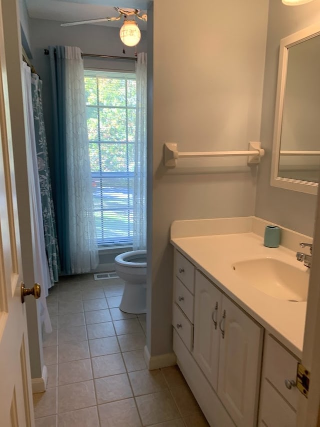 bathroom featuring tile patterned floors, vanity, and toilet