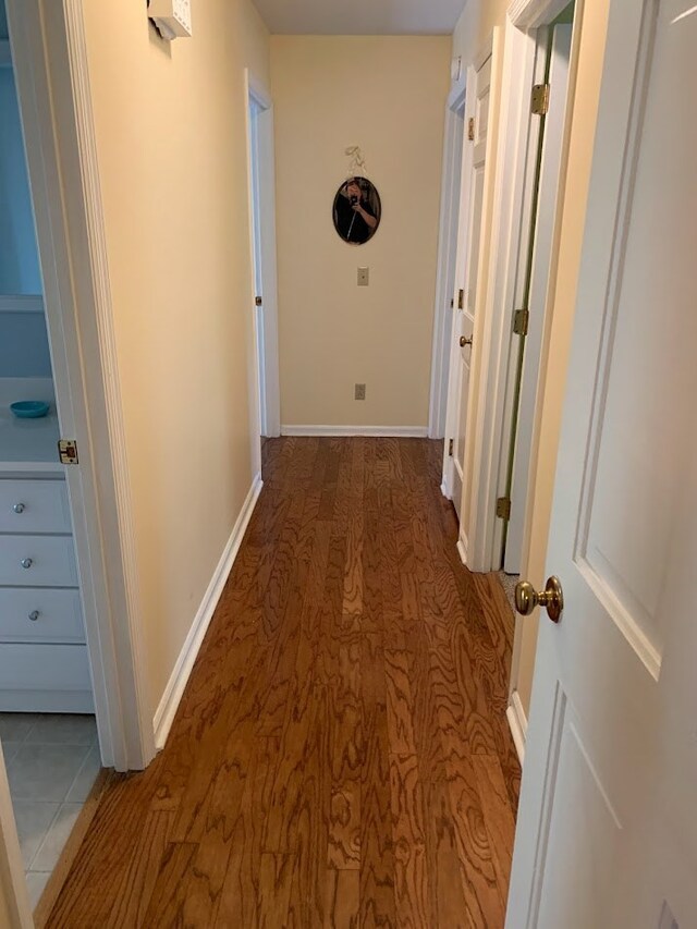 hallway with wood-type flooring