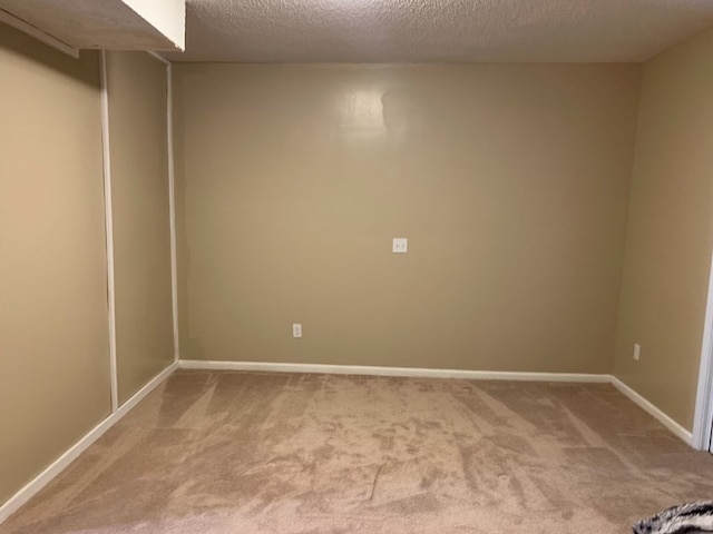 spare room with carpet flooring and a textured ceiling