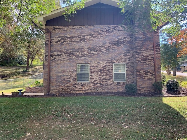 view of side of home featuring a yard