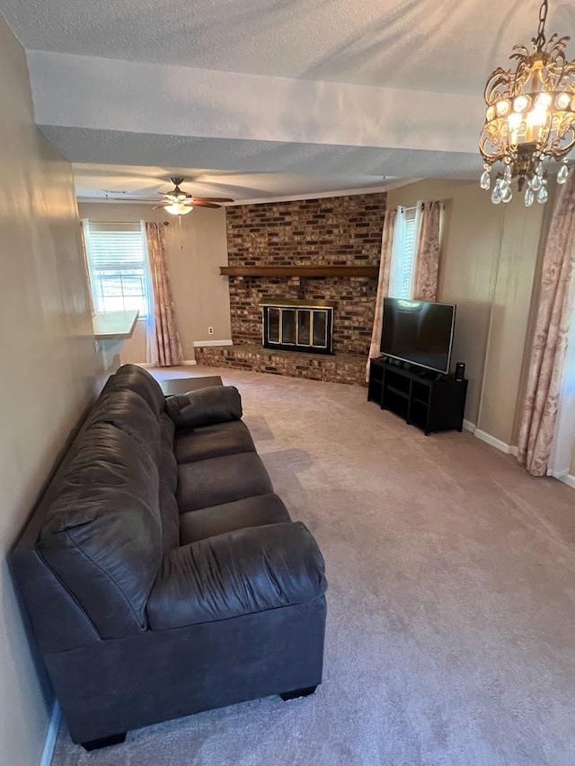 living room featuring ceiling fan with notable chandelier, a textured ceiling, carpet floors, and a brick fireplace