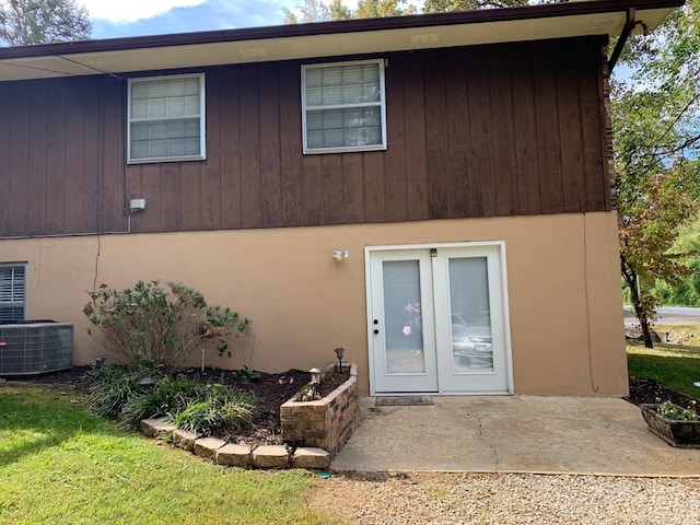 rear view of house featuring french doors and central AC