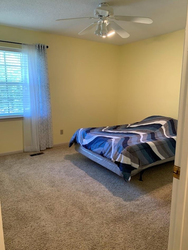 carpeted bedroom featuring ceiling fan