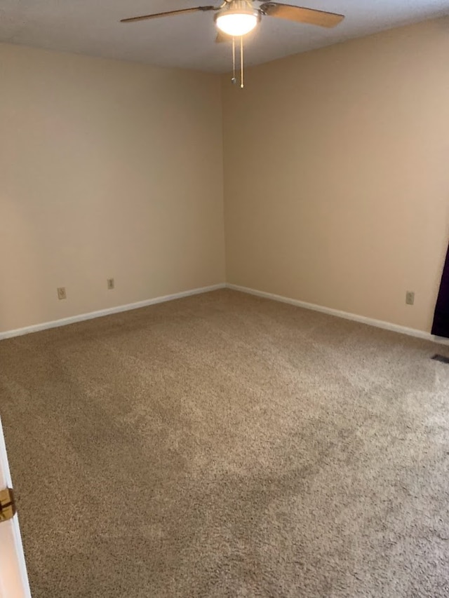 carpeted spare room with ceiling fan