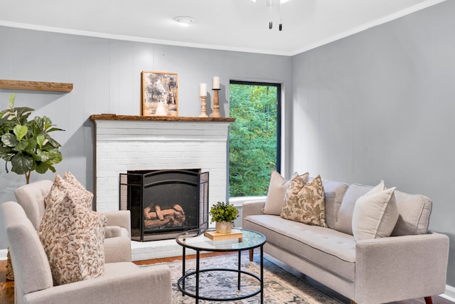 living room with a fireplace, hardwood / wood-style floors, ceiling fan, and crown molding