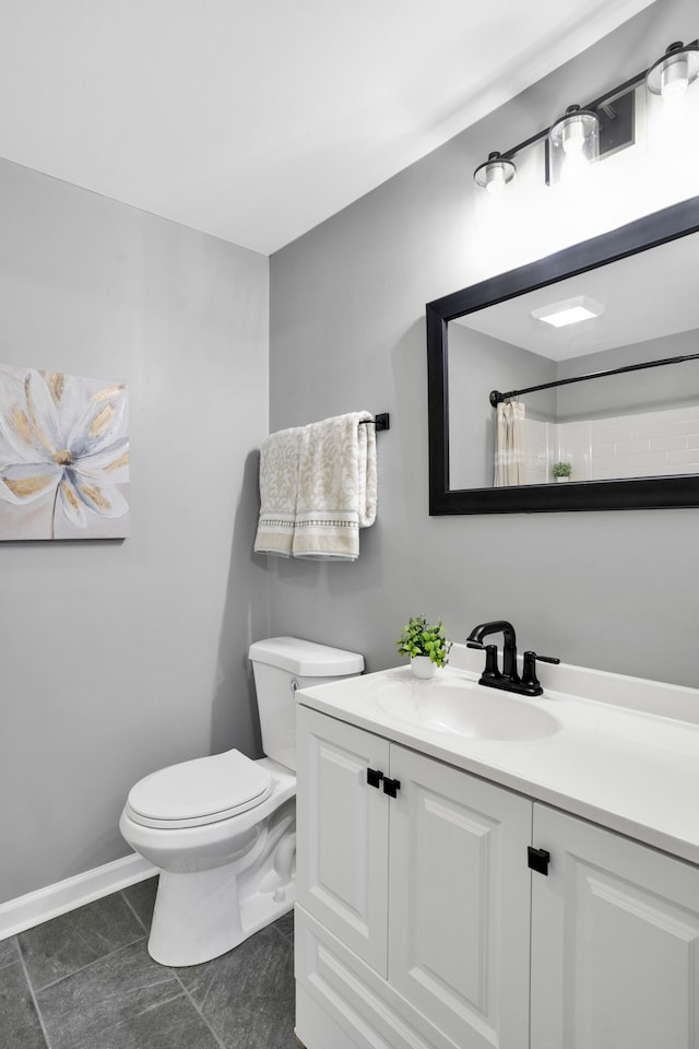 bathroom featuring toilet, a shower with curtain, vanity, and tile patterned floors