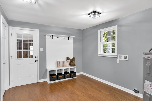 mudroom with electric water heater and hardwood / wood-style flooring