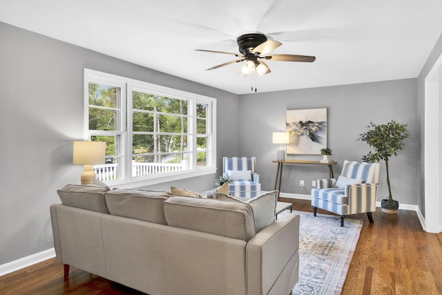 living room featuring dark hardwood / wood-style floors and ceiling fan