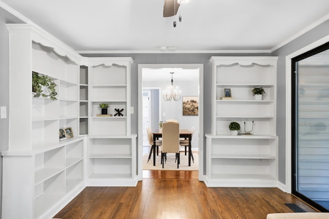 interior space with ceiling fan with notable chandelier, dark hardwood / wood-style floors, and crown molding