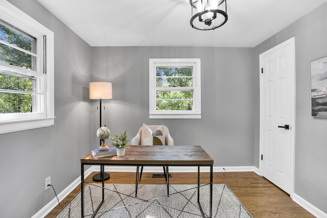 office featuring dark hardwood / wood-style floors and a notable chandelier