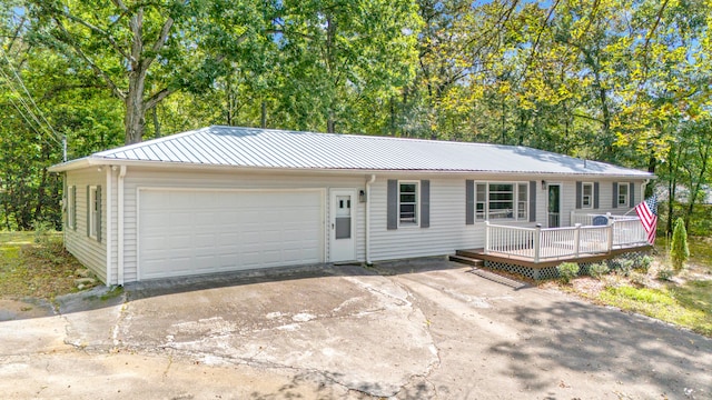 ranch-style home featuring a garage and a deck