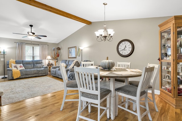 dining room featuring vaulted ceiling with beams, ceiling fan with notable chandelier, and light hardwood / wood-style floors