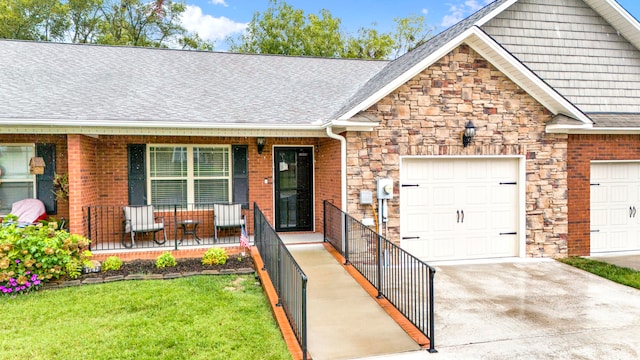 view of front of property with a front lawn, covered porch, and a garage