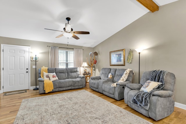 living room featuring lofted ceiling with beams, ceiling fan, and light hardwood / wood-style flooring