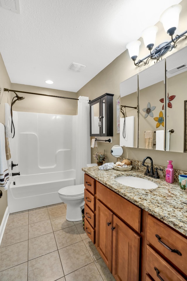 full bathroom featuring tile patterned flooring, a textured ceiling, toilet, vanity, and bathtub / shower combination