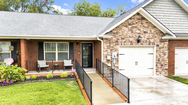 view of front facade with a garage, covered porch, and a front yard