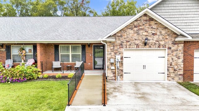 view of front of house with a front yard, a porch, and a garage