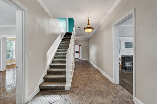 staircase featuring hardwood / wood-style flooring and ornamental molding