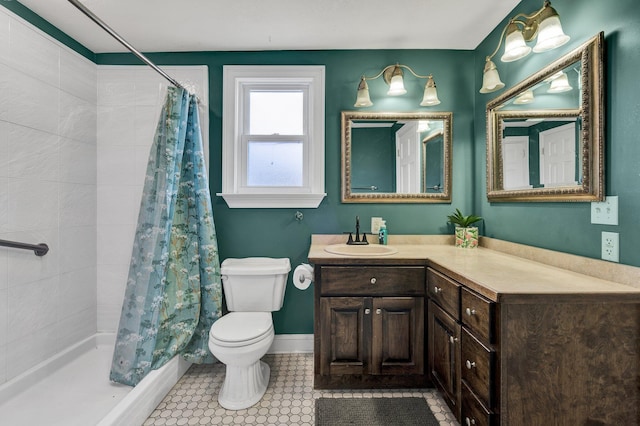 bathroom with tile patterned floors, vanity, a shower with shower curtain, and toilet