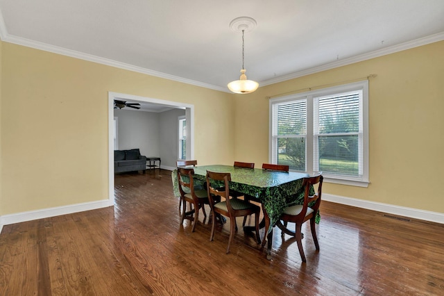 dining space with dark hardwood / wood-style floors, ceiling fan, and crown molding