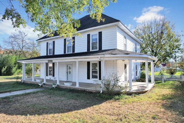 country-style home with a front lawn and covered porch