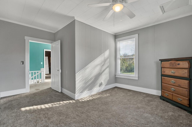 unfurnished room featuring ceiling fan, ornamental molding, and dark colored carpet